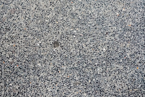 rough gray asphalt pavement surface, showcasing its detailed texture and fine gravel composition. Perfect texture for various design projects.Stone wall fence background