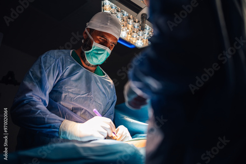 Medical professionals performing surgery with advanced equipment.