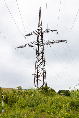 high voltage power line mast on summer cloudy day photo