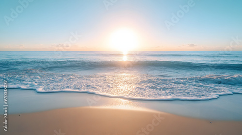 A serene ocean view from a secluded beach with the sun rising over the calm water and creating a soft golden reflection.