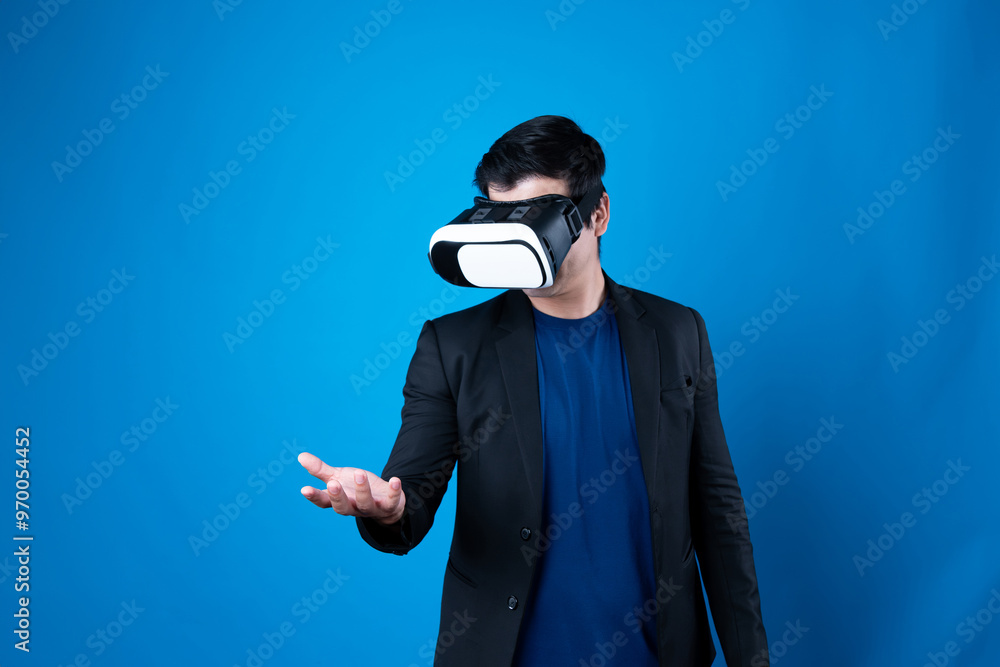 Profile of businessman wearing VR device connecting metaverse, holding stuff in the air isolated blue background futuristic analytics communication technology virtual reality copyspace. Contrivance. Profile of businessman wearing VR device connecting metaverse, holding stuff in the air isolated blue background futuristic analytics communication technology virtual reality copyspace. Contrivance.