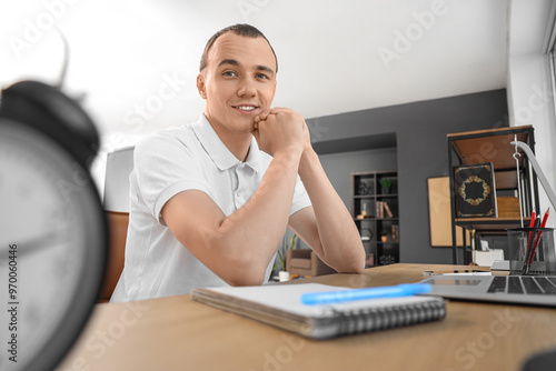 Young man working at table ...