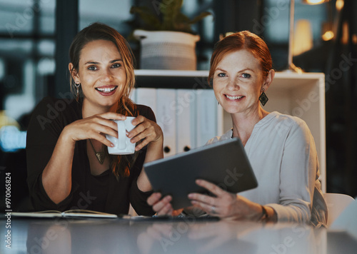 Office, women and smile at night with tablet for online research on deadline or overtime for project. People, employees and happy on portrait for teamwork, collaboration and coworking for business