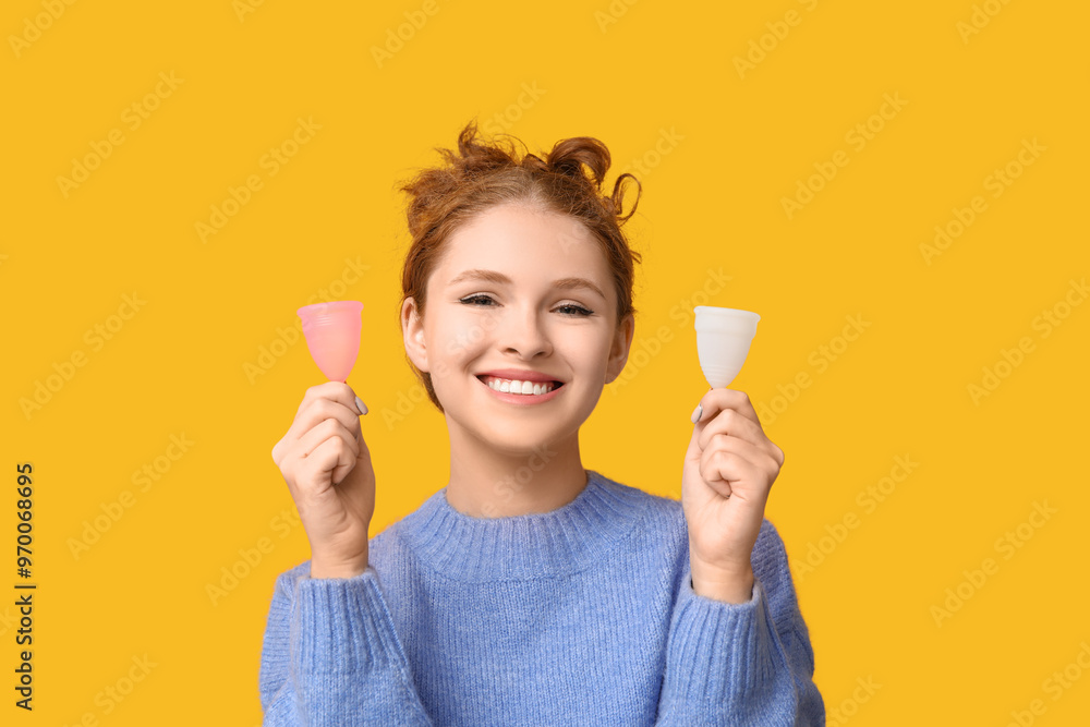 Beautiful young woman with menstrual cups on yellow background Beautiful young woman with menstrual cups on yellow background