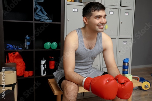 Sporty young man with boxin...