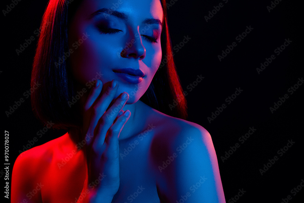 Photo of pretty girl close eyes touch face blue glowing skin enjoy feeling isolated neon color background Photo of pretty girl close eyes touch face blue glowing skin enjoy feeling isolated neon color background