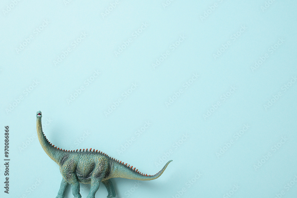 Naklejka premium Brachiosaurus dinosaur toy isolated on blue background.