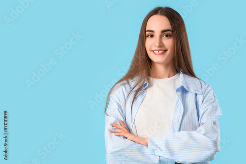 Young beautiful woman on blue background