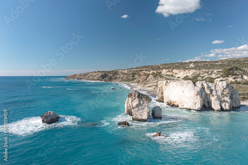 Turquoise mediterranean sea gently lapping the beautiful white rocks of aphrodite's birthplace in cyprus photo