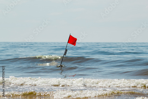 Solitary Red Flag at Sea photo