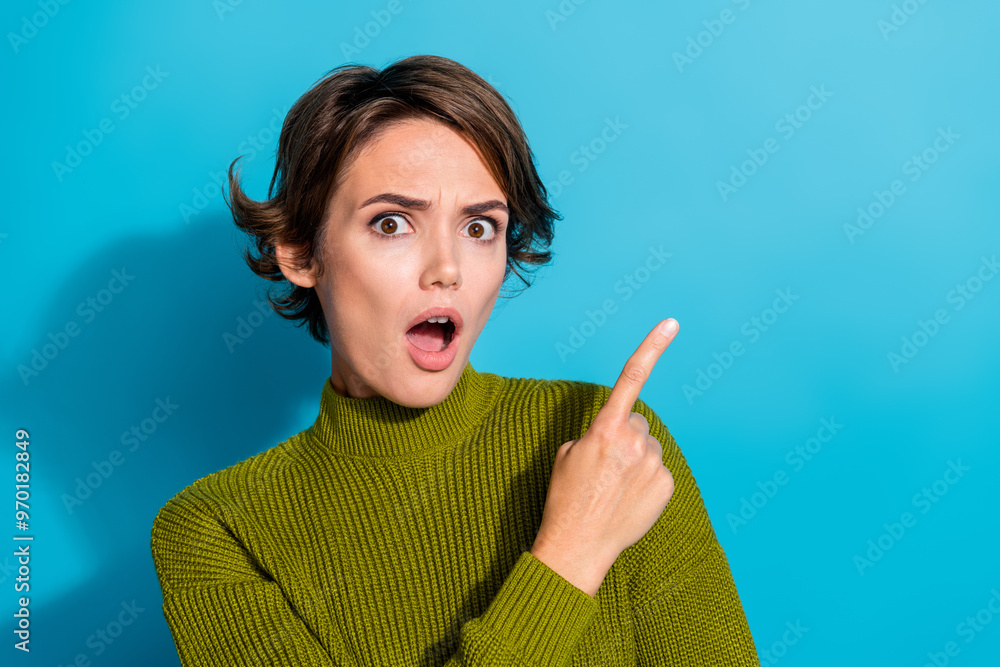 Obraz premium Photo of amazed impressed girl wear trendy khaki clothes arm demonstrate empty space wow news banner isolated on cyan color background
