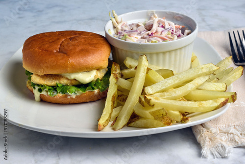 haddock fillet sandwich  with cole slaw and fries photo