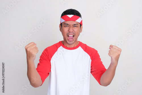 Indonesia man clenched fist showing enthusiastic expression photo