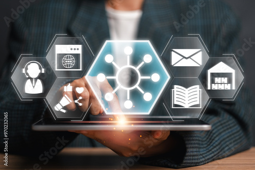 A business professional interacts with digital icons representing the omni channel concept, showcasing integrated customer experience and strategy.