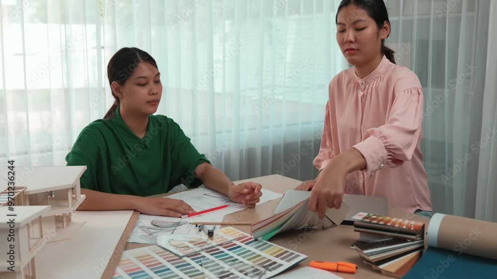 Slow motion interior designer using architectural equipment draw a blueprint while interior designer select appropriate color and material from samples based on customers clients demand. Variegated Slow motion interior designer using architectural equipment draw a blueprint while interior designer select appropriate color and material from samples based on customers clients demand. Variegated
