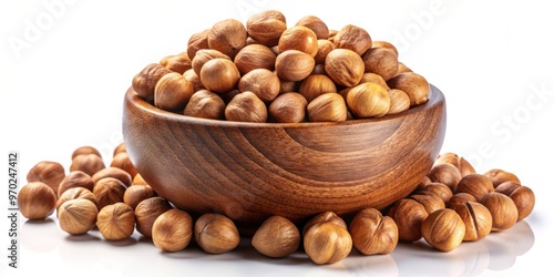 A torrent of brown charoli nuts bursts forth from the wooden bowl, scattering across the white canvas in photo