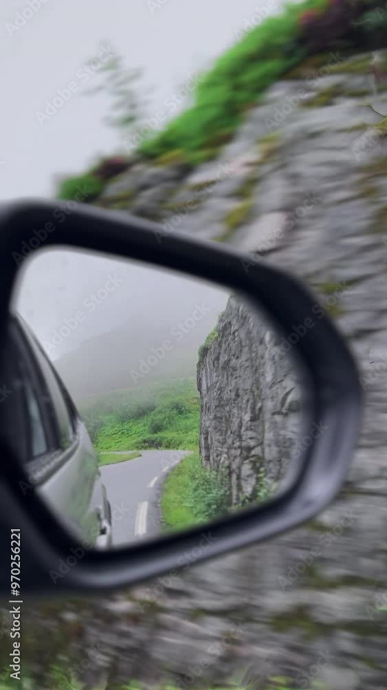 A winding 4K, scenic road captured beautifully, reflected in the side mirror of a vehicle, view from car in Norway, Portrait Orientation A winding 4K, scenic road captured beautifully, reflected in the side mirror of a vehicle, view from car in Norway, Portrait Orientation