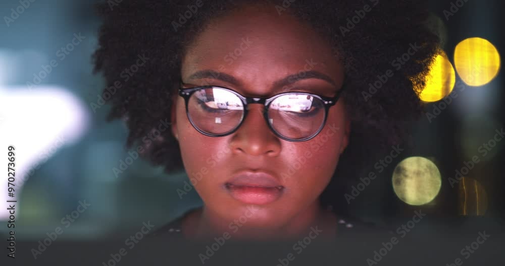 Computer, night and a business black woman at work in her office, reading information for research. Face, glasses and a serious young employee working on a laptop during the evening late shift