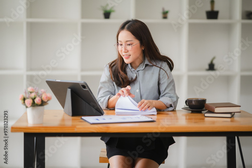 Focused Female Professional Navigates Digital Documents at a Modern Workspace 