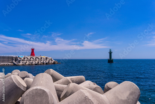 Eupcheon-ri, Yangnam-myeon, Gyeongju-si, Gyeongsangbuk-do, South Korea - August 1, 2019: Tetrapods with the background of Eupcheon Lighthouse at Eupcheon Port photo