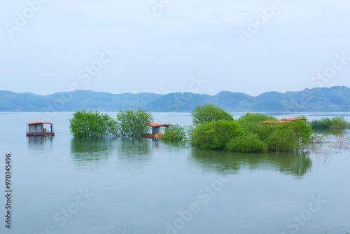 Yesan-gun, Chungcheongnam-do, South Korea - April 28, 2019: Aerial view of fishing houses and willow trees on Yedang Reservoir in spring