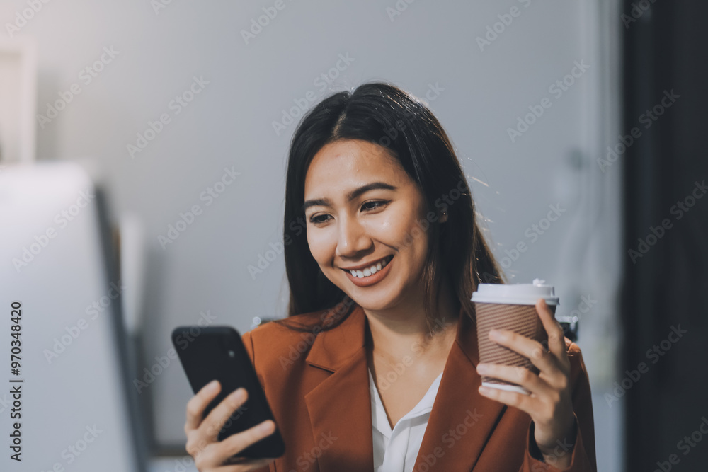 A woman is talking on her cell phone while holding a coffee cup A woman is talking on her cell phone while holding a coffee cup