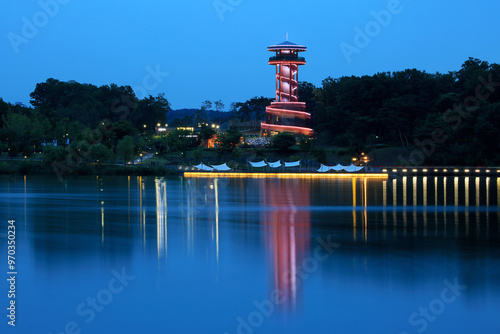 Gwanggyo New Town, Suwon-si, Gyeonggi-do, South Korea - June 13, 2019: Nighr view of an observatory near the lake at Gwanggyo Lake Park photo