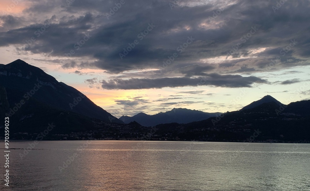 Mountains surrounding Lake Como during cloudy sunset Mountains surrounding Lake Como during cloudy sunset