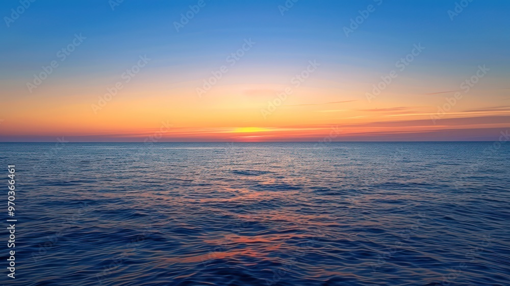 Obraz premium A serene ocean view at sunset, showcasing vibrant colors reflecting on the water's surface.