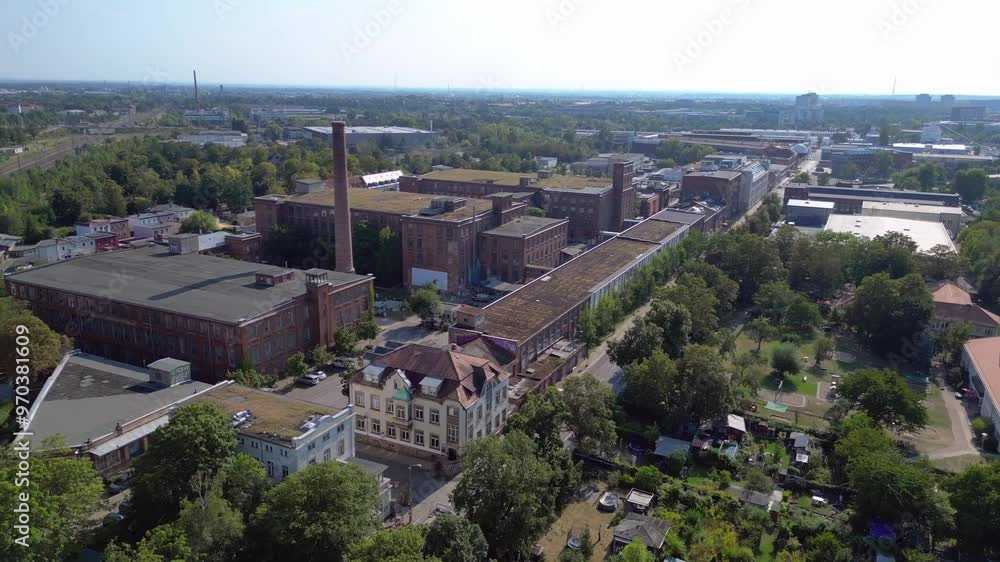 Leipzig cotton spinning mill factory industrial architecture, characterized by brick buildings and a chimney. Beautiful aerial view flight fly reverse drone Leipzig cotton spinning mill factory industrial architecture, characterized by brick buildings and a chimney. Beautiful aerial view flight fly reverse drone