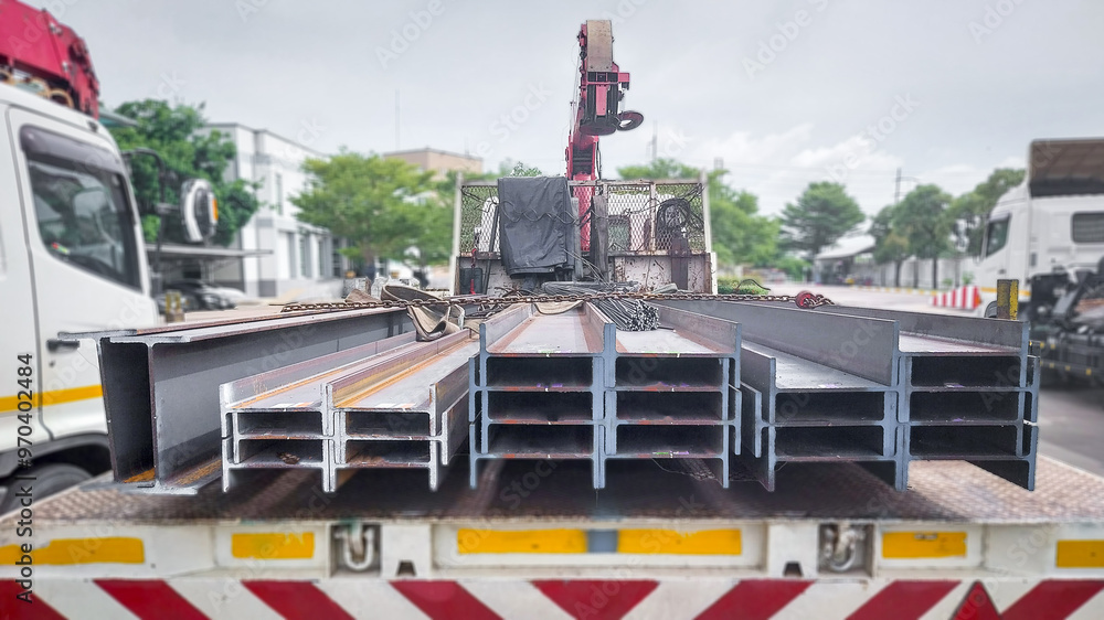 Naklejka premium Metal forming steel beams at the metal products warehouse, H-beam steel and Wi-Frank steel. For large structures or building columns, focus only on the raw materials used in building construction.