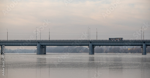 A bridge spans a river with a train crossing over it