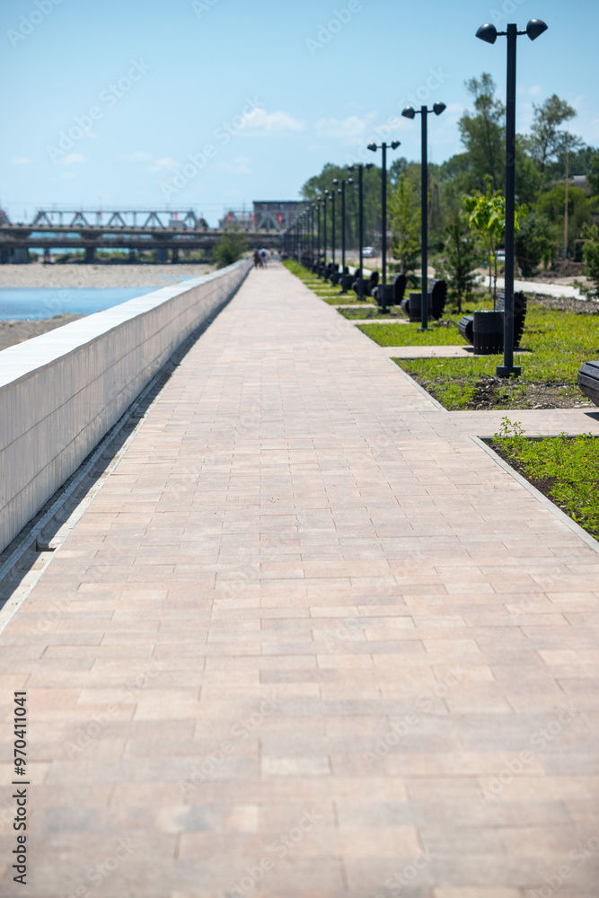 A long walkway with a bridge in the background A long walkway with a bridge in the background