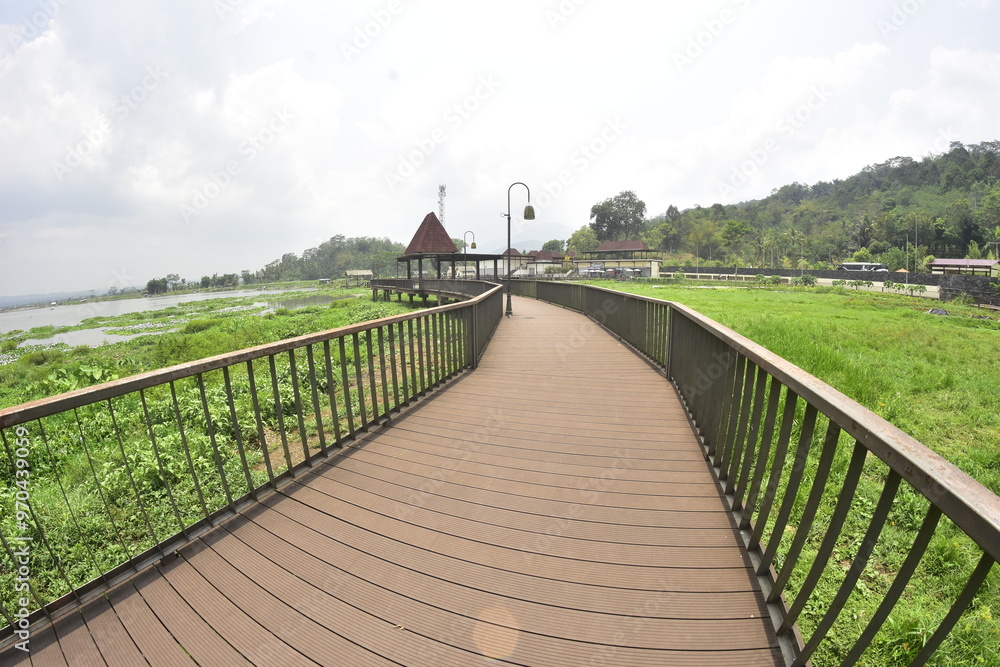 Fototapeta premium The bridge and wooden architecture built above Rawa Pening Lake has now become an aesthetic tourist spot for the people of Indonesia.