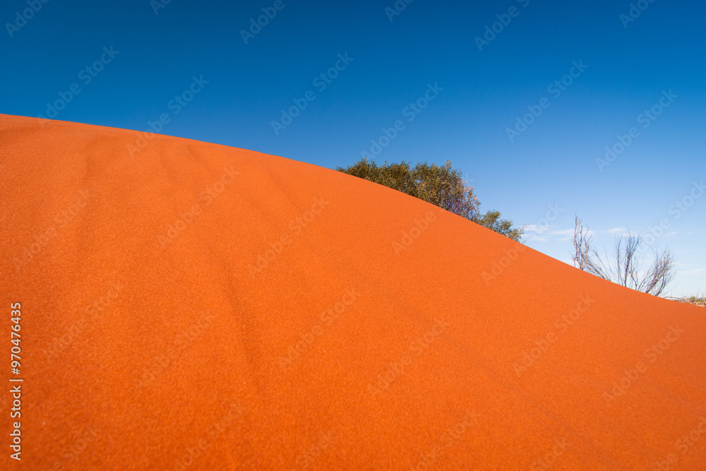 Abstract curve of a red dune against a blue sky in central Australia Abstract curve of a red dune against a blue sky in central Australia