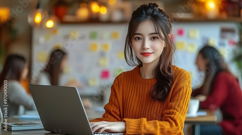 A dynamic startup environment featuring a woman working on her laptop, with whiteboards covered in post-its and business ideas, energetic team collaboration happening in the background, photo