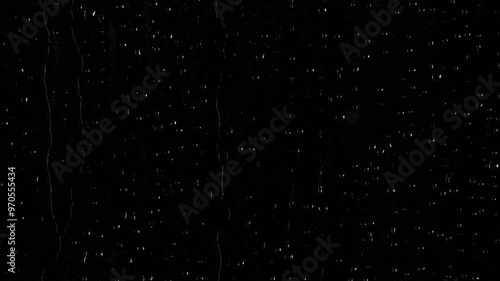 Closeup water rainfall, rain drops falling on window glass over black background