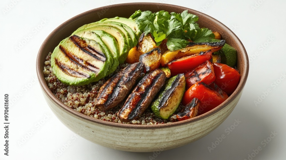 A bowl of quinoa topped with grilled vegetables and avocado, displayed on a clean white background A bowl of quinoa topped with grilled vegetables and avocado, displayed on a clean white background