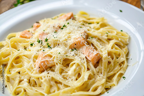 pasta with salmon in a creamy sauce, sprinkled with grated cheese