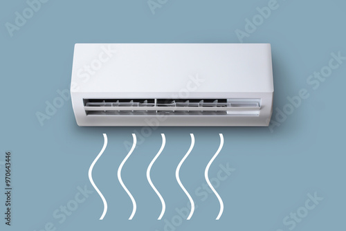 White air conditioner hangs on a gray-blue wall. Air conditioner with air flow of white wavy lines.