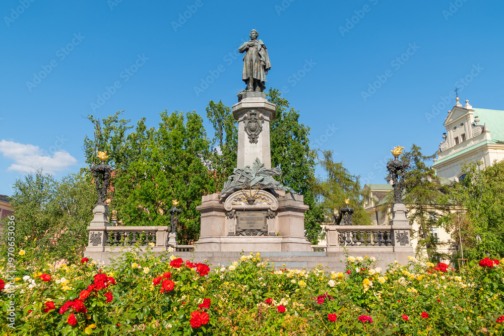 Fototapeta premium Adam Mickiewicz Monument in summer among flowers. August 9, 2024. Warsaw, Poland.