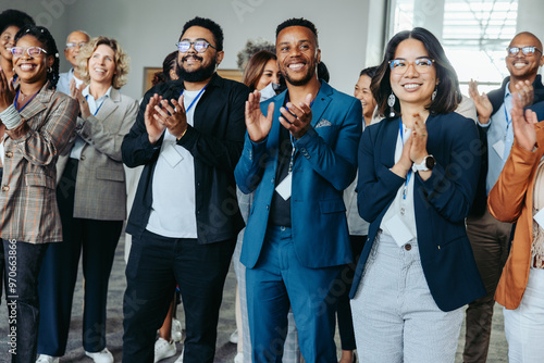 Diverse colleagues clapping at conference, happy employees celebrating success, unity in business photo