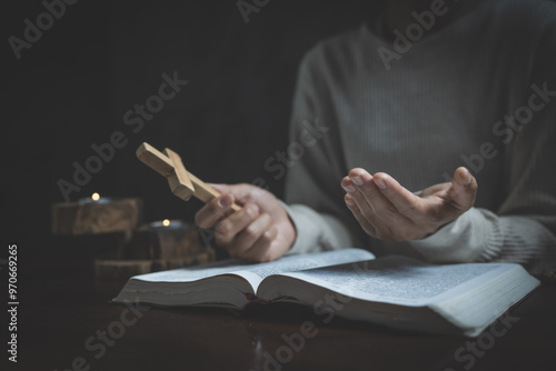 woman praying on holy bible in the morning. woman hand with Bible praying. Hands folded in prayer on a Holy Bible in church concept for faith, spirituality and religion.