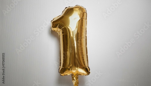 A shiny gold balloon in the shape of the number one birthday celebration for party 