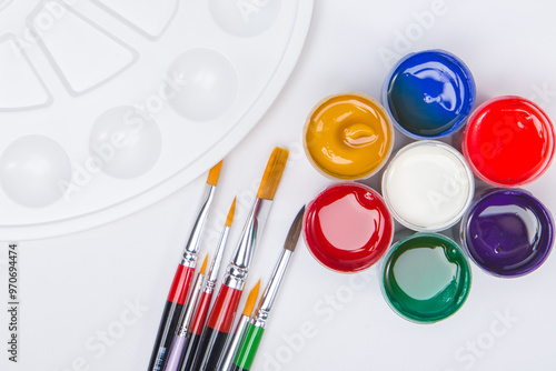 Wallpaper Mural Paintbrushes of different sizes, pellets and gouache paints. Concept. View from above. Torontodigital.ca