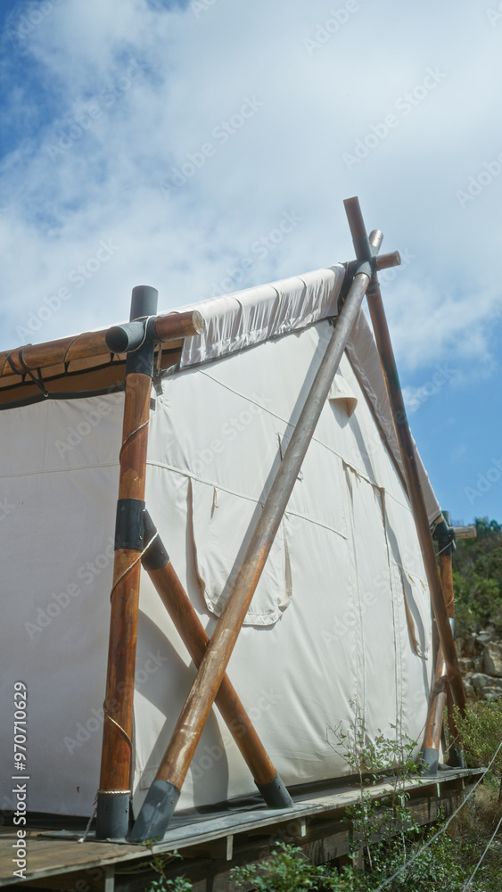 A rustic african camping tent in nature during an adventure trip, capturing the essence of outdoor exploration with the sky in the background. A rustic african camping tent in nature during an adventure trip, capturing the essence of outdoor exploration with the sky in the background.