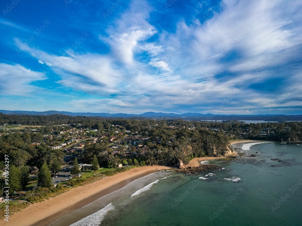 Aerial view of a coastal town with a sandy beach and clear blue sky. Aerial view of a coastal town with a sandy beach and clear blue sky.