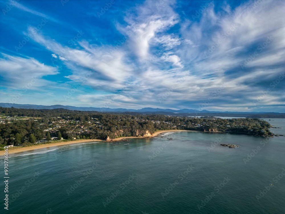 Aerial view of a coastal town with a beach and mountains Aerial view of a coastal town with a beach and mountains