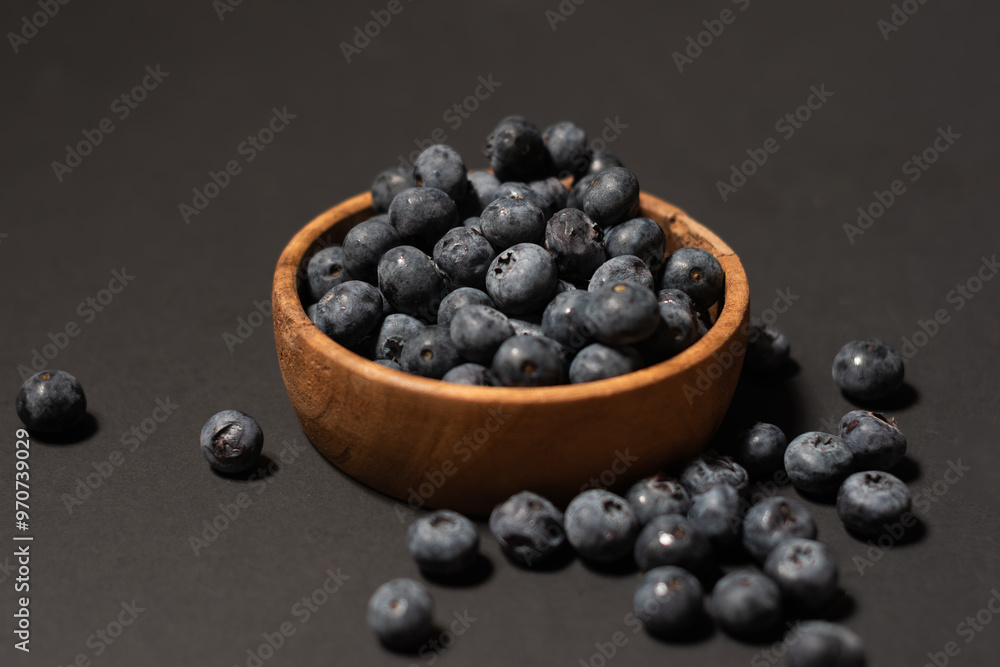 Delicious fresh sweet blueberries on a dark background, a bowl of blueberries in dark background, Blueberries in a wooden bowl on a black, healthy food Delicious fresh sweet blueberries on a dark background, a bowl of blueberries in dark background, Blueberries in a wooden bowl on a black, healthy food