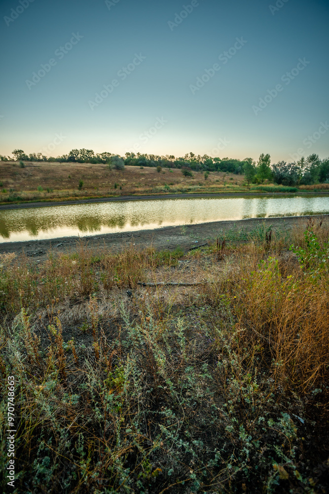 Morning on the lake , august morning , summer landscape with a lake . Landscape photography with sunrise on the lake , beautiful scenery on the beach,trach sollution on the pond.Beautiful nature Morning on the lake , august morning , summer landscape with a lake . Landscape photography with sunrise on the lake , beautiful scenery on the beach,trach sollution on the pond.Beautiful nature